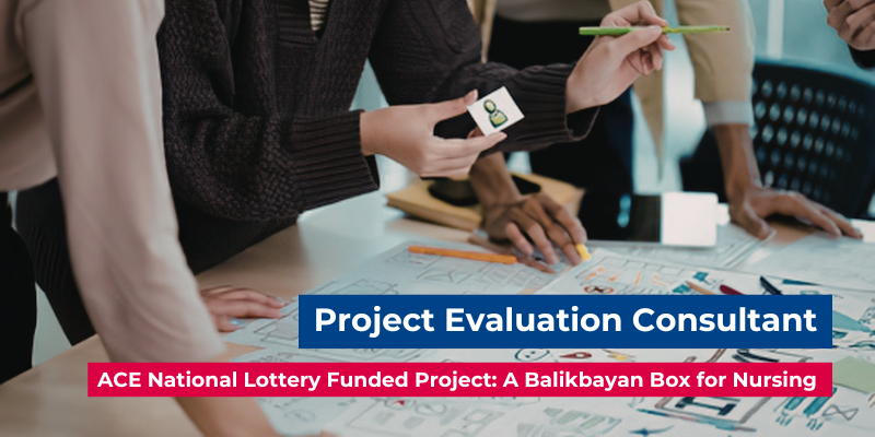 A group of around 4 people, who are only visible from waist level, review documents and charts on a desk; one person holds a small image and pencil. Digitally added text reads: "Project Evaluation Consultant" and "ACE National Lottery Funded Project: A Balikbayan Box for Nursing".