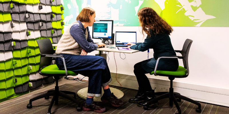 Two people sat at a computer