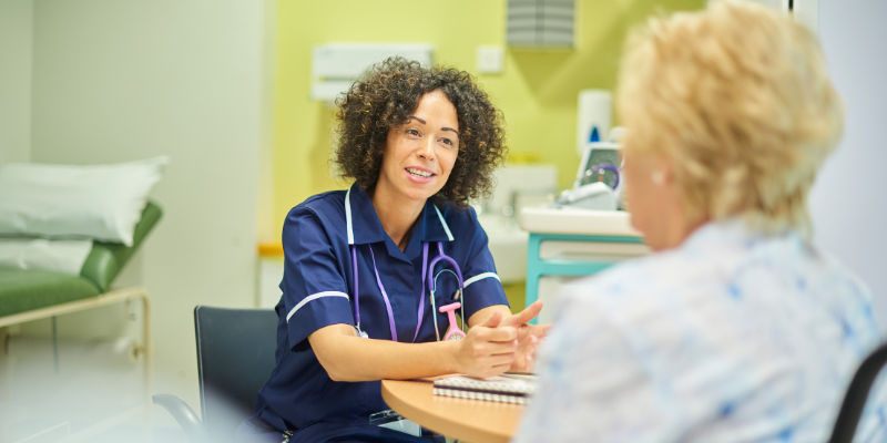 A nurse talks to a woman patient.