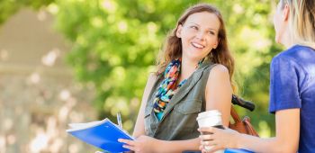 Woman in wheelchair chatting to nursing