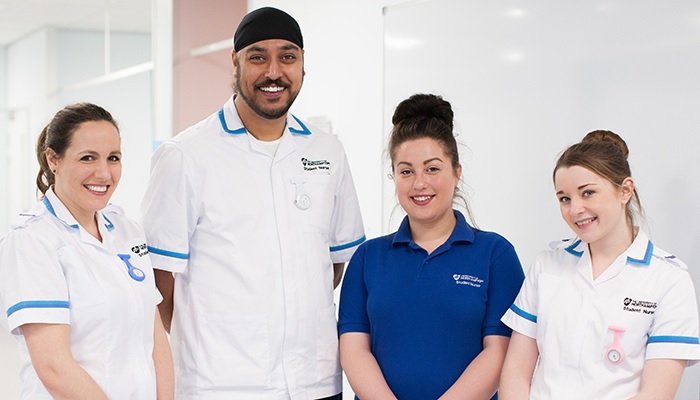 Four student nurses smiling