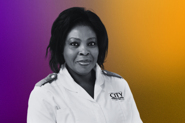 female nursing associate smiling wearing a white uniform 