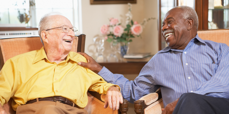 Two older men talking in a care home Two older men talking in a care home