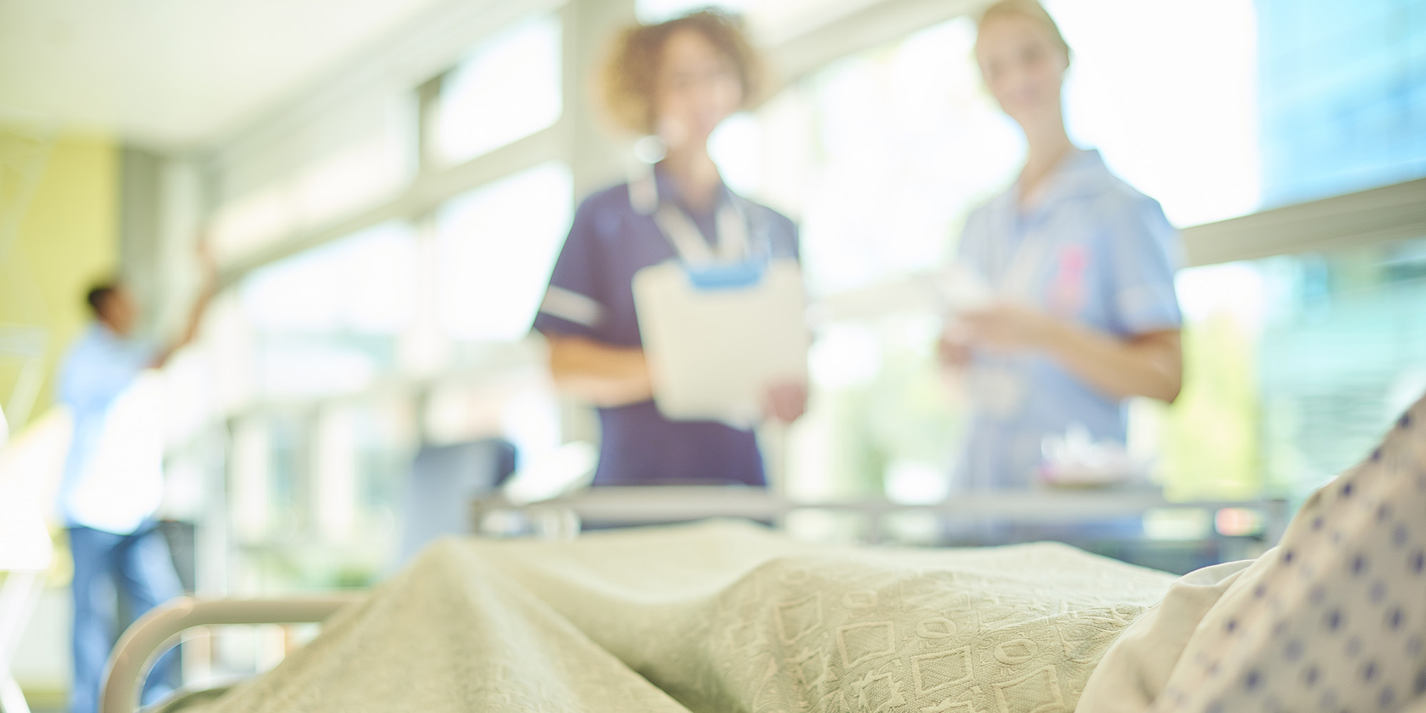 Nurses at a patient's bedside