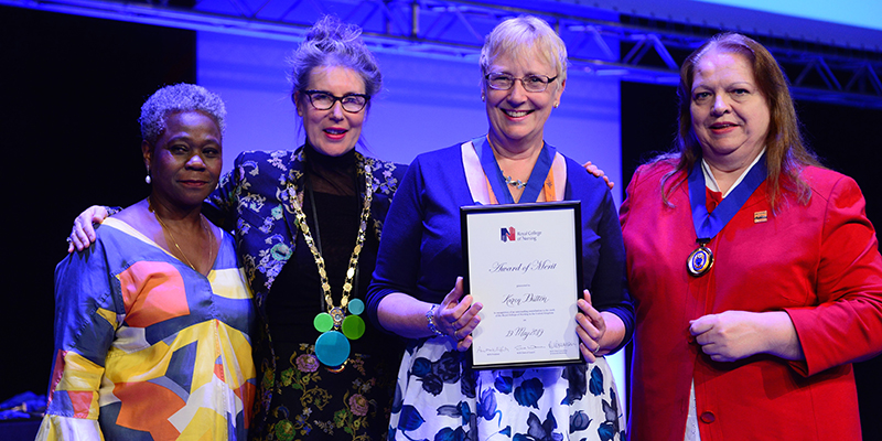 Cumbria Branch's Karen Dutton receiving her RCN Award of Merit at RCN Congress 2019, flanked by Chief Executive and General Secretary Dame Donna Kinnair, RCN President Professor Anne Marie Rafferty, and Chair of RCN Council Sue Warner