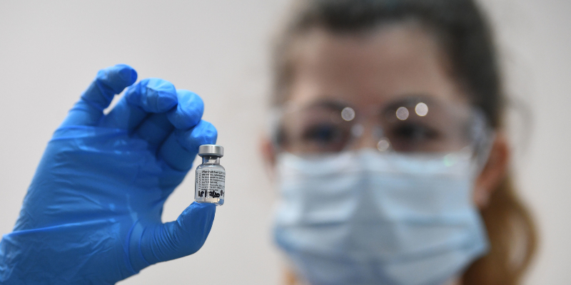 Nurse holding COVID-19 vaccine