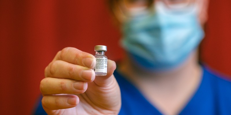 Nurse holding vaccine vial