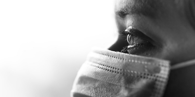 black and white close up of nurse in mask