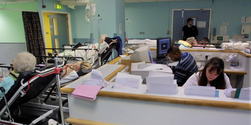 Patients being treated on beds in a hospital waiting room