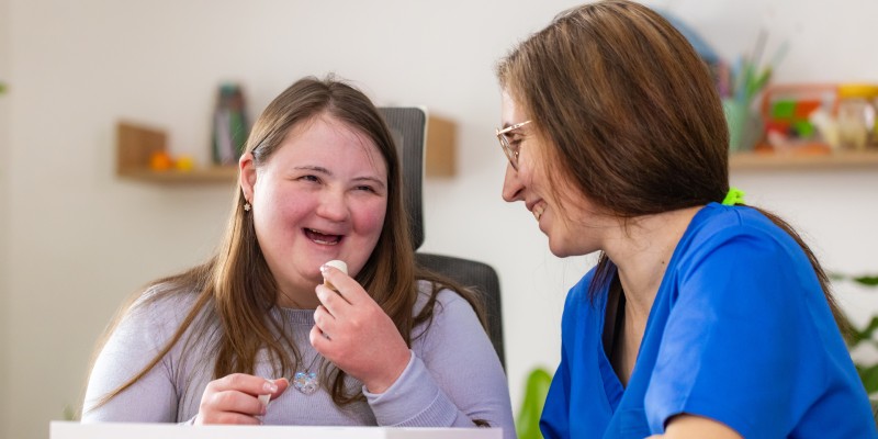 Two people sat together, smiling