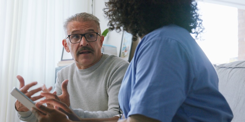 Male patient talks to nurse