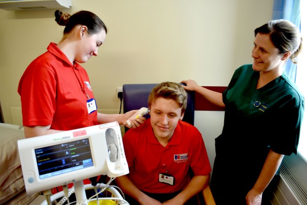 Luke with a cadet and nurse in a clinical setting