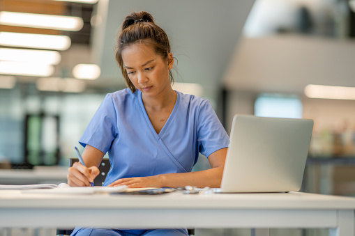 A nurse studying at a desk
