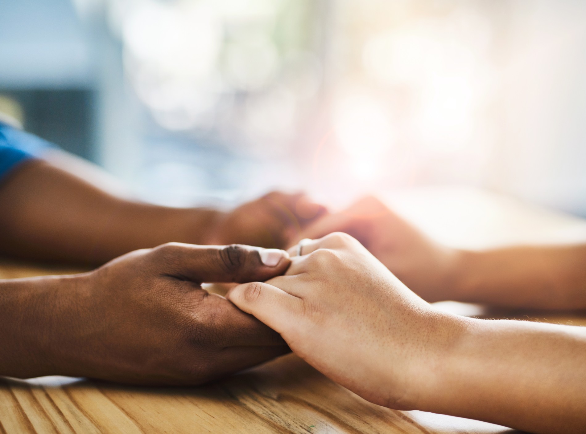 People holding hands in support