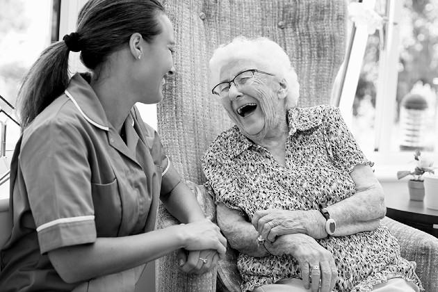 nurse with older lady laughing
