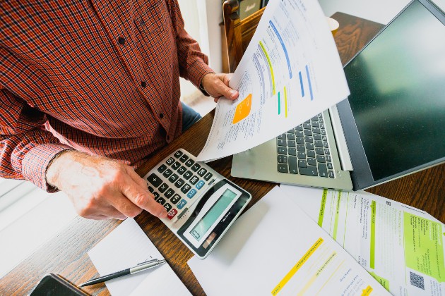 Man working with bills and a calculator