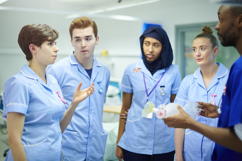 Group of nursing students being taught on placement