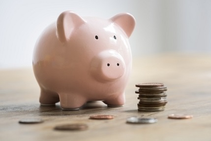 Piggy bank surrounded by coins