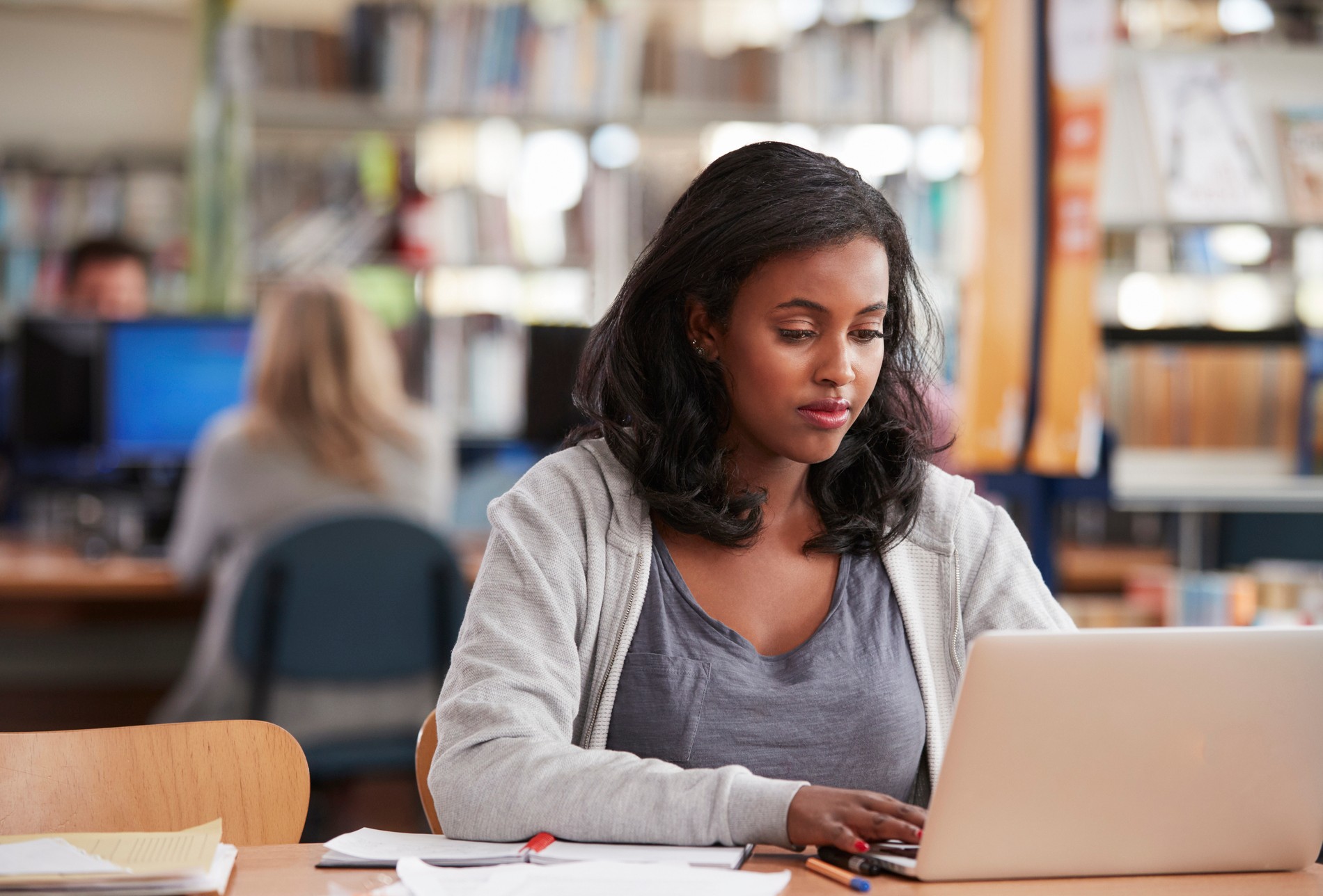 Mature student working in library