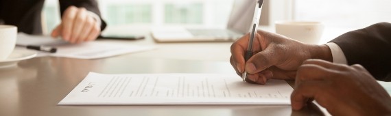 close-up of hand signing document