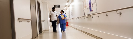 Two nurses walking down corridor