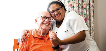 Nurse in care home with patient