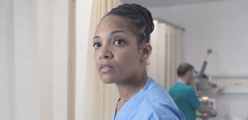 Image of concerned nurse in a hospital setting