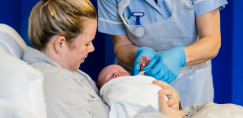 Midwife with new mother and baby