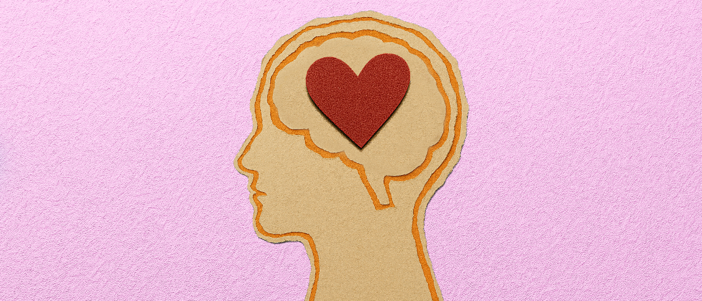 A scrapbook-style illustration of a human head in profile, with the brain area filled with a big, red paper heart