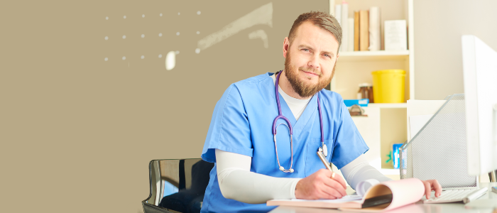 male nursing writing at desk male nursing writing at desk