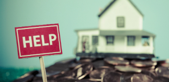 Help sign with house in background