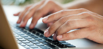 Hands typing on a keyboard