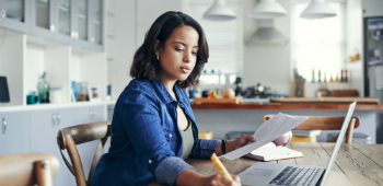 Woman working on laptop at home