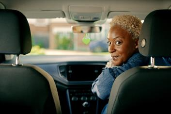 Why Chose LV IMG Blonde woman looking back in LV car
