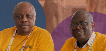 Two nursing support workers looking ahead and smiling.