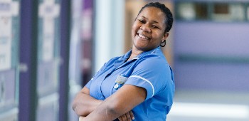 Female nurse smiling in corridor