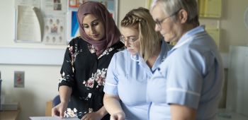 Consultant nurse talking to other nurses Consultant nurse talking to other nurses