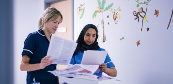 Two nurses looking at patient notes