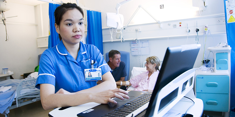 Nurse monitoring a computer in a ward