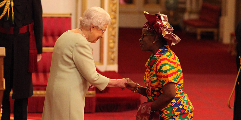 Cecilia Anim receiving her CBE from the Queen