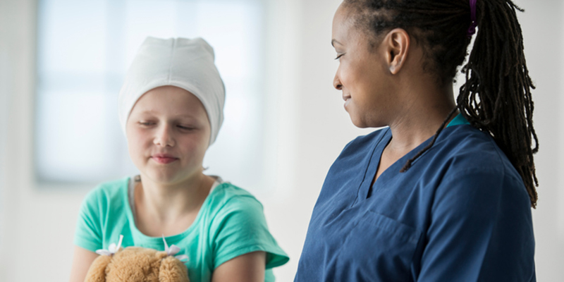 Nurse comforting sick child