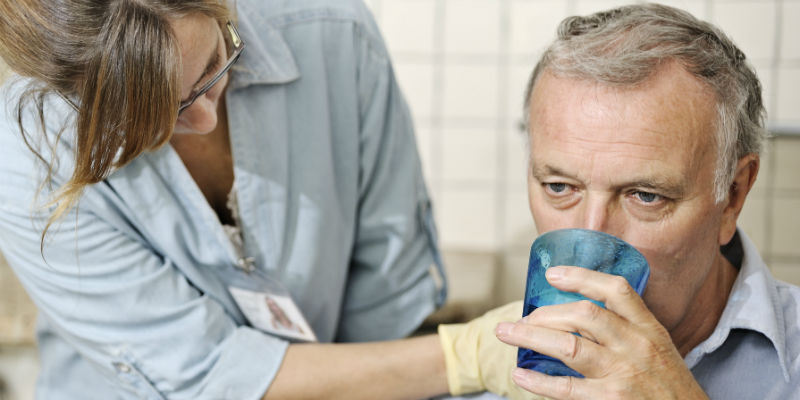Nursing professional caring for patient with dysphagia