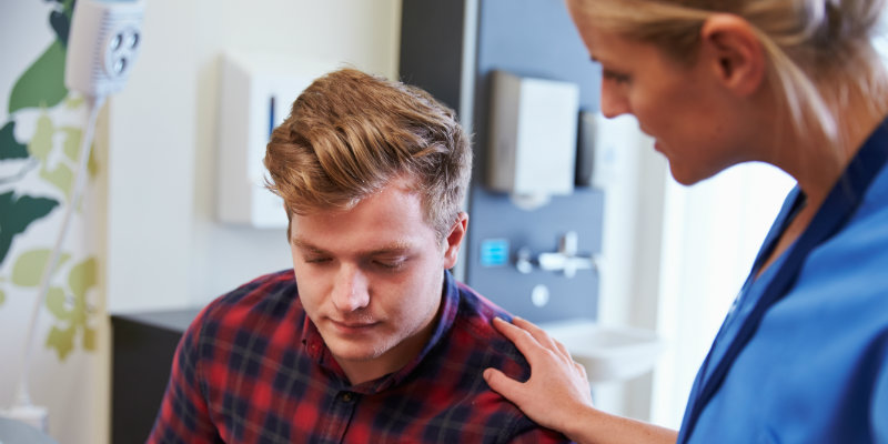 Nurse talking to male patient