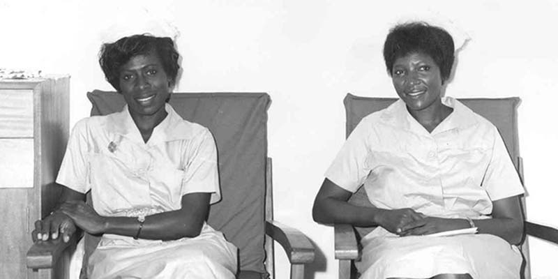 Two nurses sat next to one another in chairs