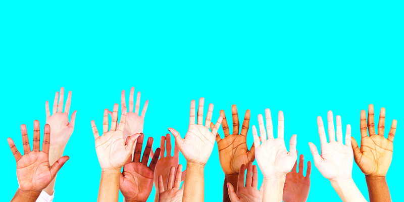 A group of hands stretched up in the air