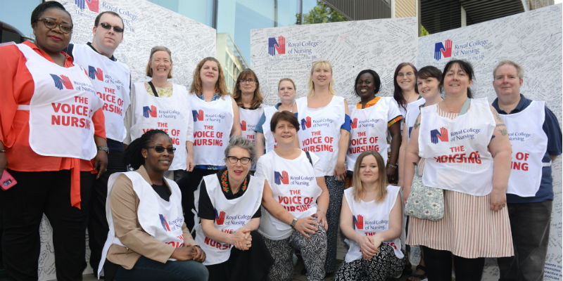 Group of members with giant letter outside department of health