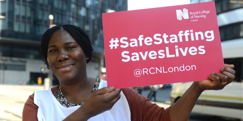 London member holding safe staffing placard