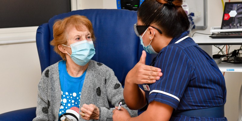 Nurse May Parsons, right, administers the UK's first COVID-19 vaccine to Margaret Keenan in Coventry on 8th December 2020