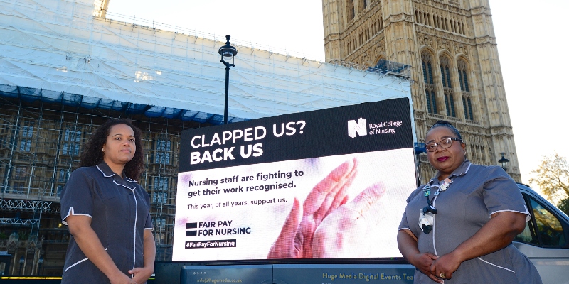 RCN members with our fair pay for nursing billboard reading "Clapped us? Back us" outside the Houses of Parliament