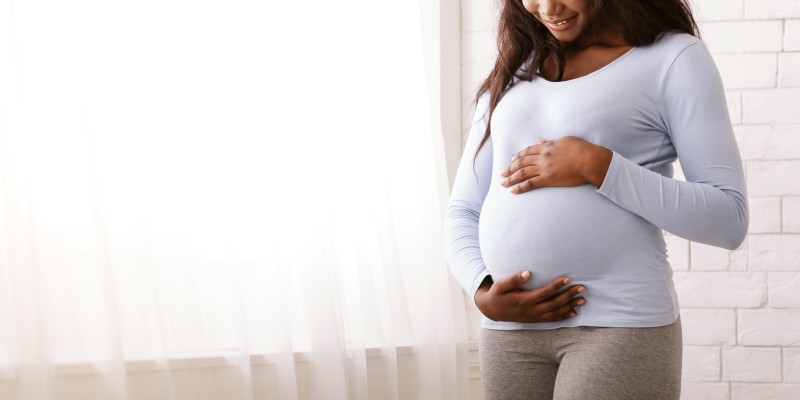 Pregnant woman holding belly